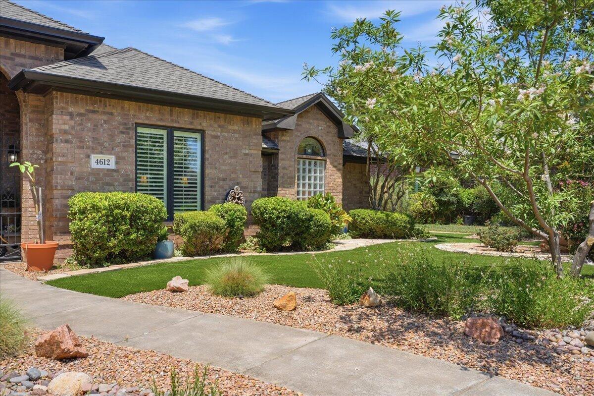 4612 100th Street Lubbock, TX 79424 - Photo 4 of 55 a front view of a house with garden