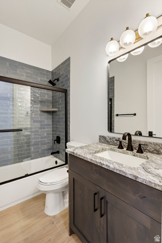 2862 South Mountain Rnch Road Cedar City, UT 84720 - Photo 50 of 64 Bathroom featuring a dark wood-finish vanity with a light stone-finish countertop, undermount sink, and matte black fixtures