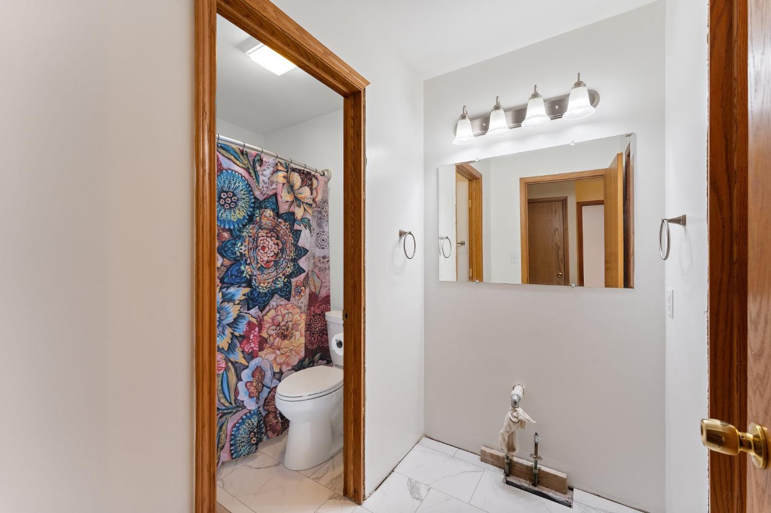 117 Indian Ridge Michigan City, IN 46360 - Photo 9 of 10 a bathroom with a toilet and a shower curtain