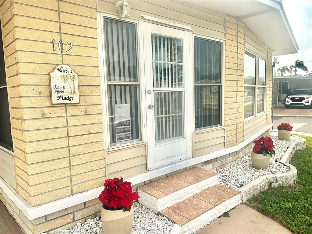 2000 East Bay Drive, Unit 102 Largo, FL 33771 - Photo 1 of 17 a view of a porch with a chairs
