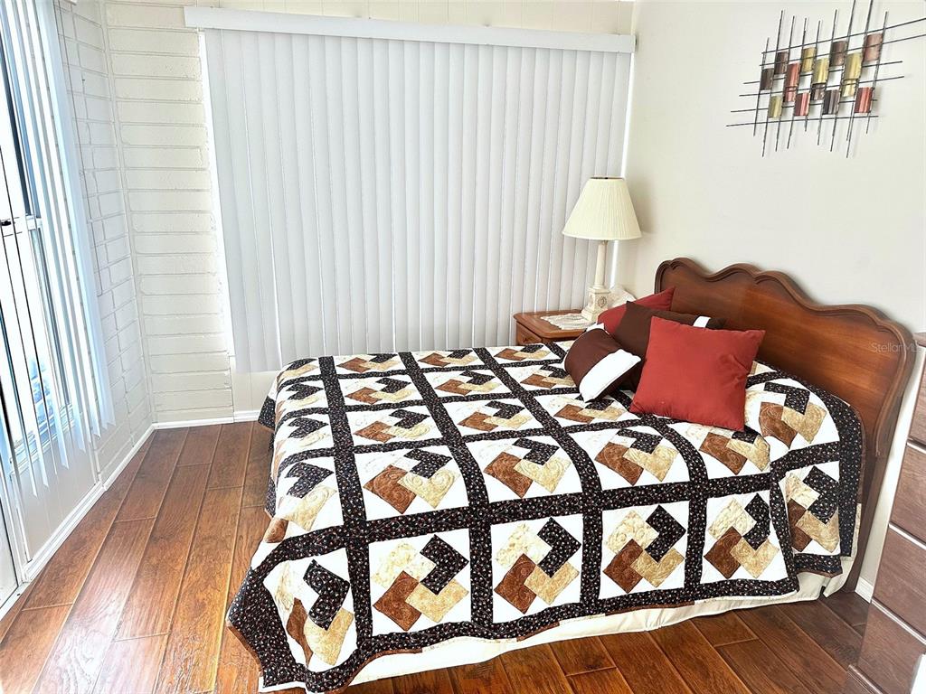 2000 East Bay Drive, Unit 102 Largo, FL 33771 - Photo 11 of 17 a bed sitting in a bedroom next to a window