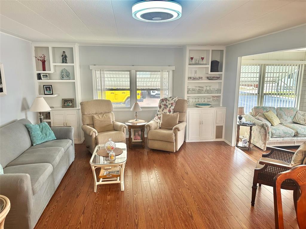 2000 East Bay Drive, Unit 102 Largo, FL 33771 - Photo 6 of 17 a living room with furniture a dining table and a bookshelf