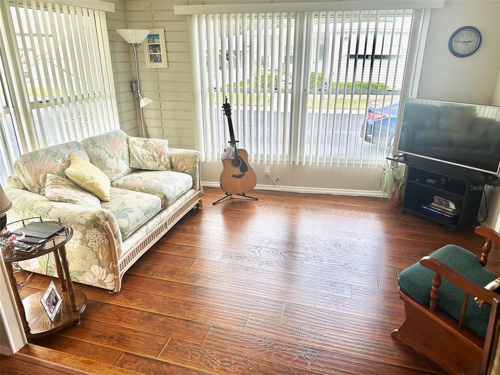 2000 East Bay Drive, Unit 102 Largo, FL 33771 - Photo 8 of 17 a living room with furniture and a wooden floor