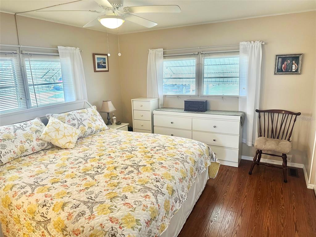 2000 East Bay Drive, Unit 102 Largo, FL 33771 - Photo 9 of 17 a bedroom with a bed and wooden floor