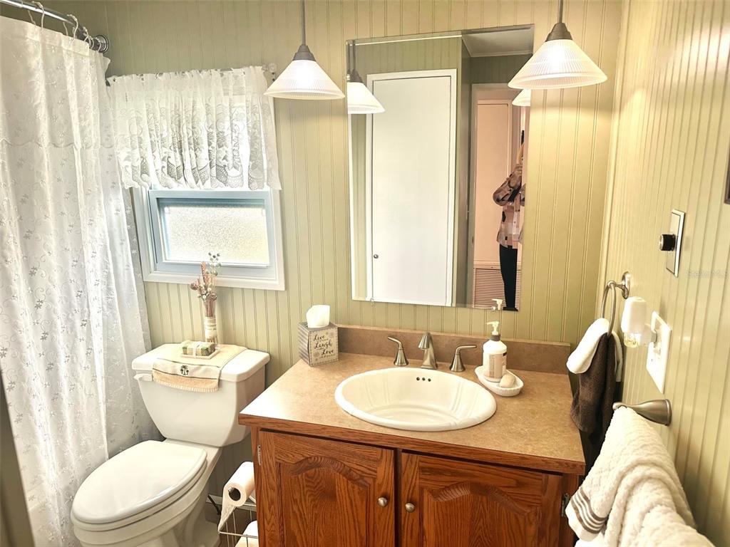 2000 East Bay Drive, Unit 102 Largo, FL 33771 - Photo 10 of 17 a bathroom with a granite countertop sink and a mirror
