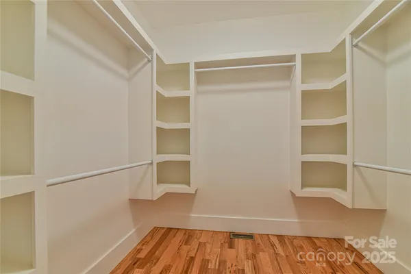 a view of walk in closet with empty racks