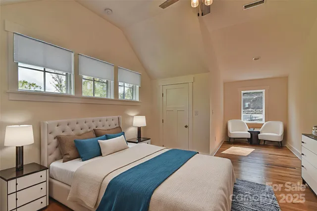 a bedroom with a bed and wooden floor