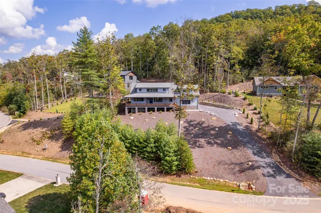 an aerial view of a house with a yard pool patio and outdoor seating
