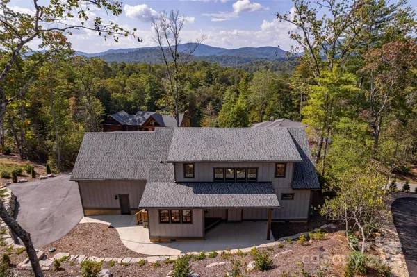 an aerial view of a house with a yard