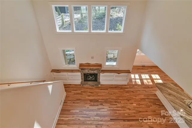 a view of a room with wooden floor and window