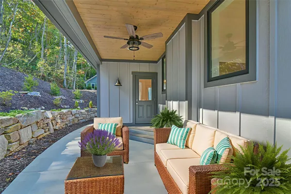 a living room with furniture and a potted plant