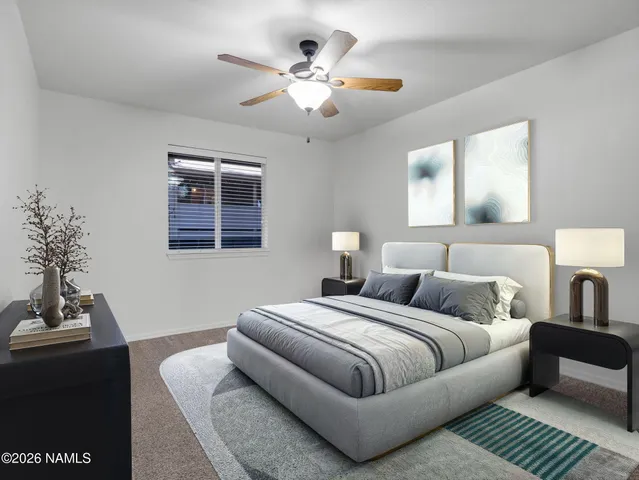 a bedroom with bed and a chandelier