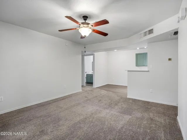 a view of an empty room with a ceiling fan