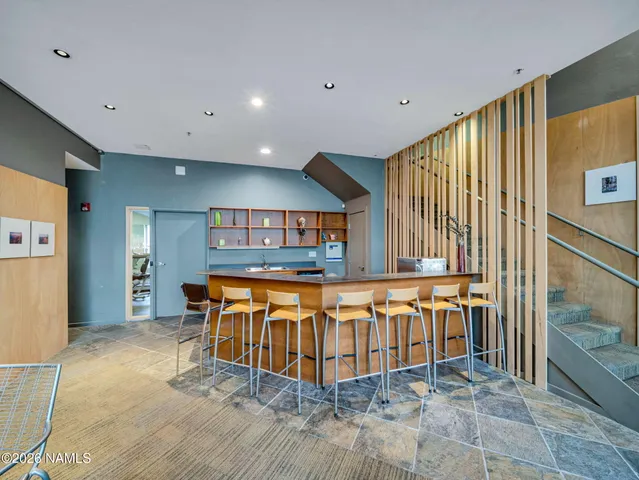 a living room with patio furniture and a fireplace