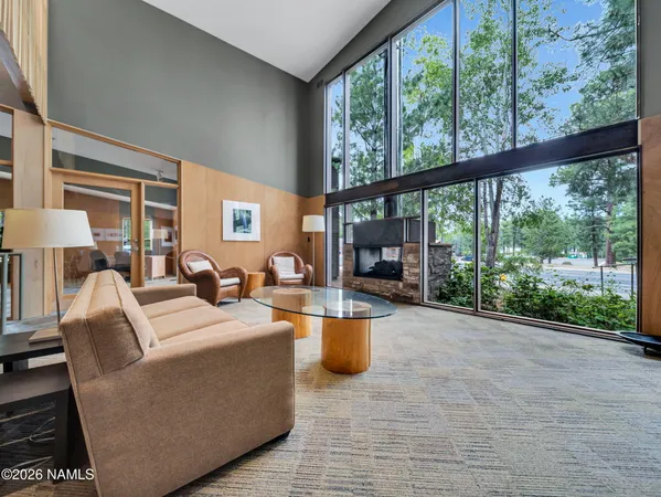a view of a hallway with wooden floor and a window