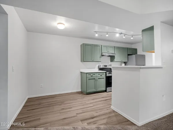 a kitchen with a sink and a refrigerator