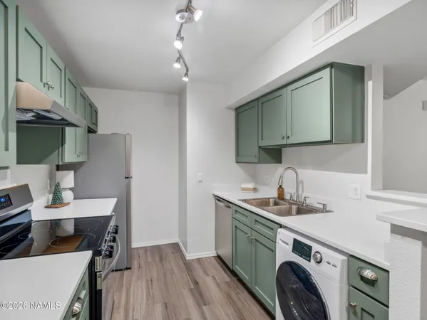 a kitchen with a sink a stove and cabinets