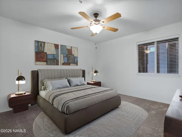 a bedroom with a large bed and a window