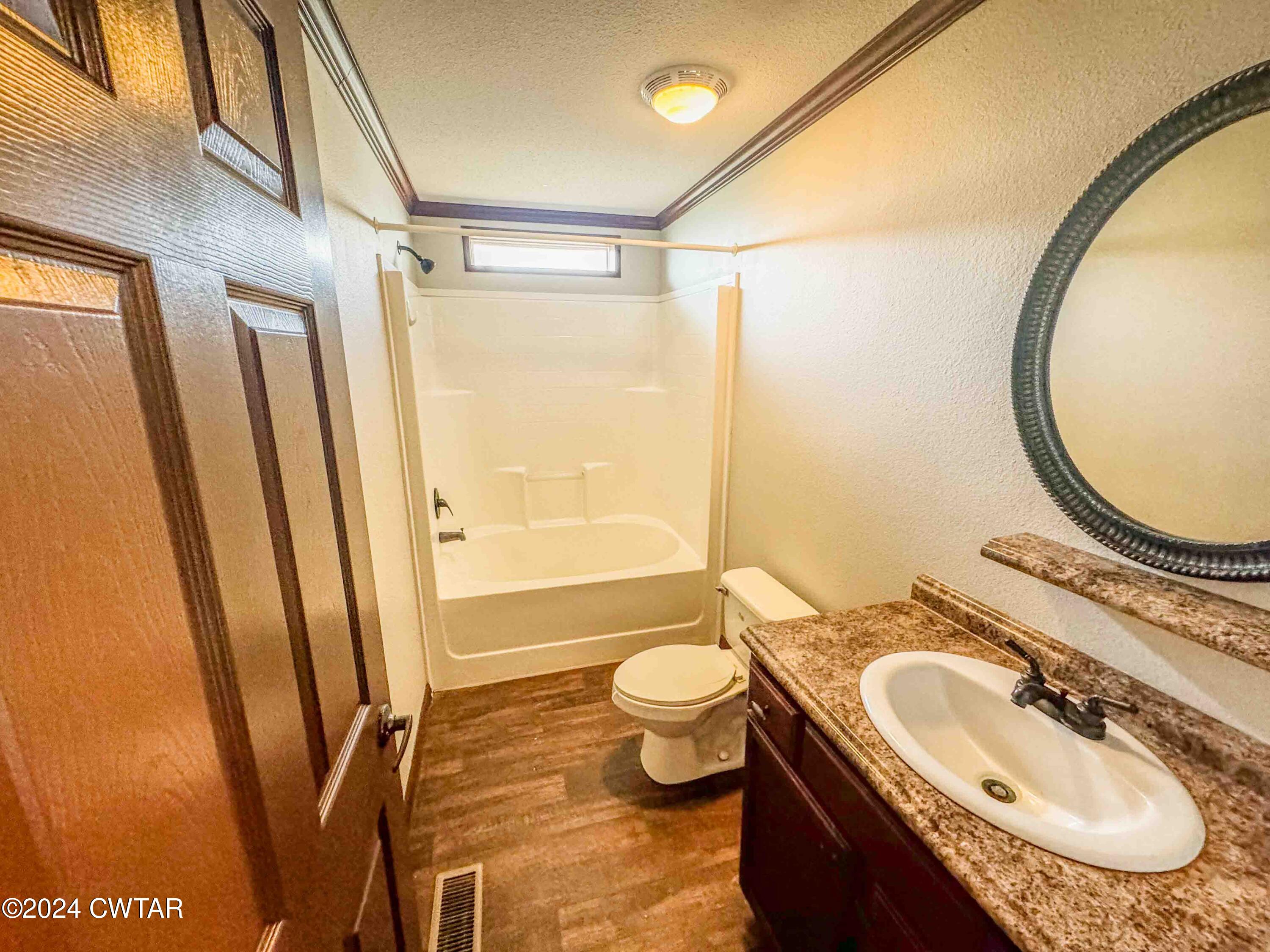 3345 Buchanan Road Buchanan, TN 38222 - Photo 23 of 40 a bathroom with a granite countertop sink toilet and a mirror