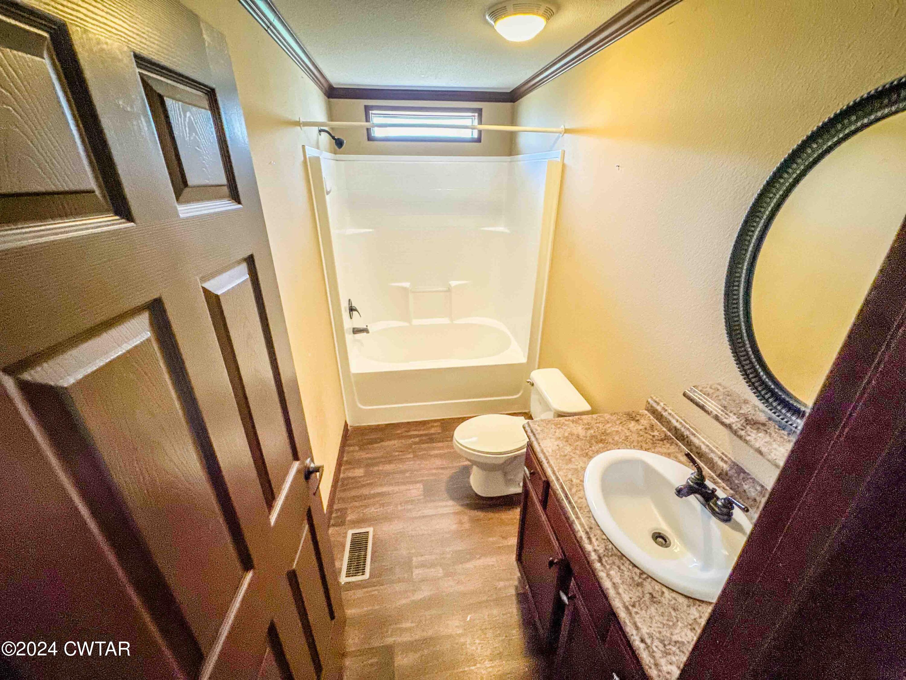 3345 Buchanan Road Buchanan, TN 38222 - Photo 5 of 40 a bathroom with a sink a mirror and a shower