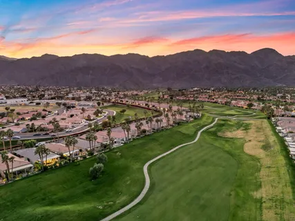 a view of a lush green hillside and houses