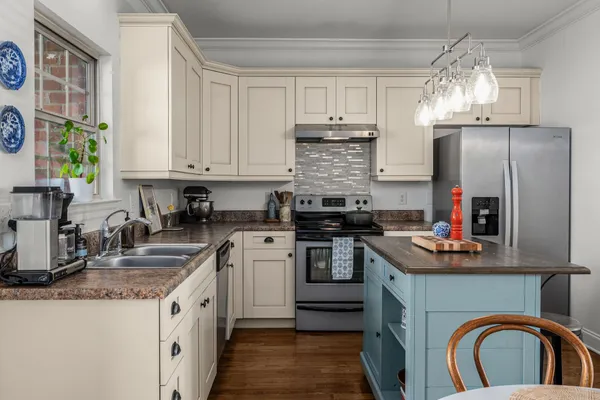 a kitchen with stainless steel appliances granite countertop a sink stove and refrigerator