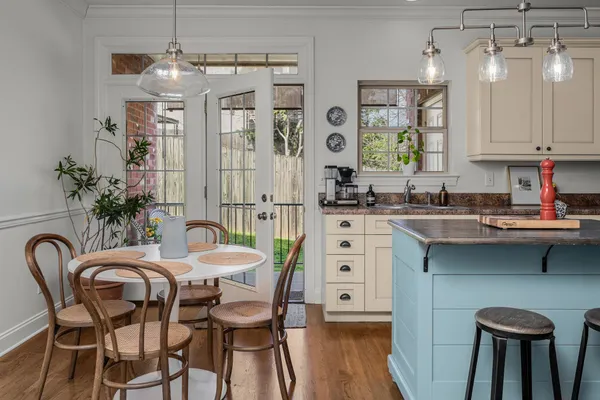 a kitchen with a table chairs sink and cabinets
