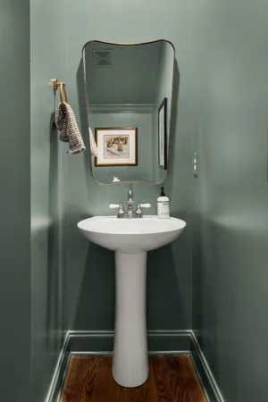 a bathroom with a sink toilet and mirror