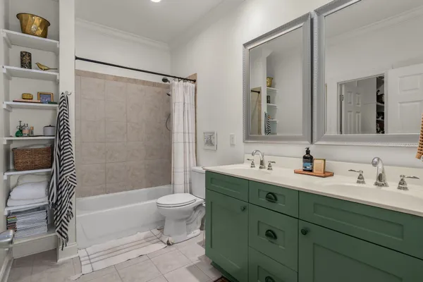 a bathroom with a double vanity sink toilet and shower