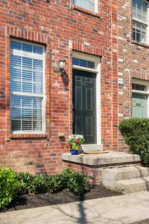 a front view of a house with potted plants