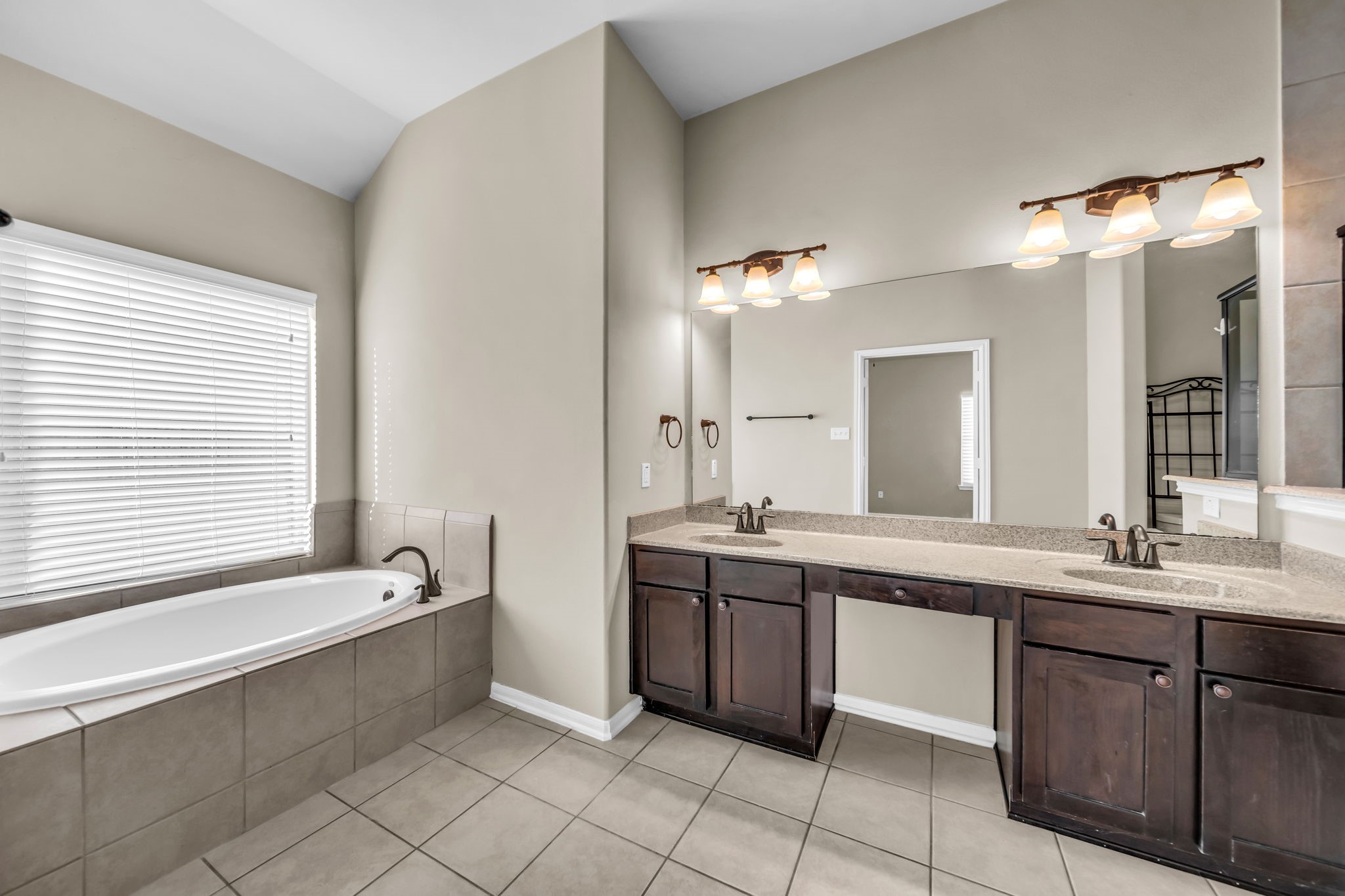 2614 Winding Creek Way Conroe, TX 77385 - Photo 11 of 23 a bathroom with a tub sink and mirror