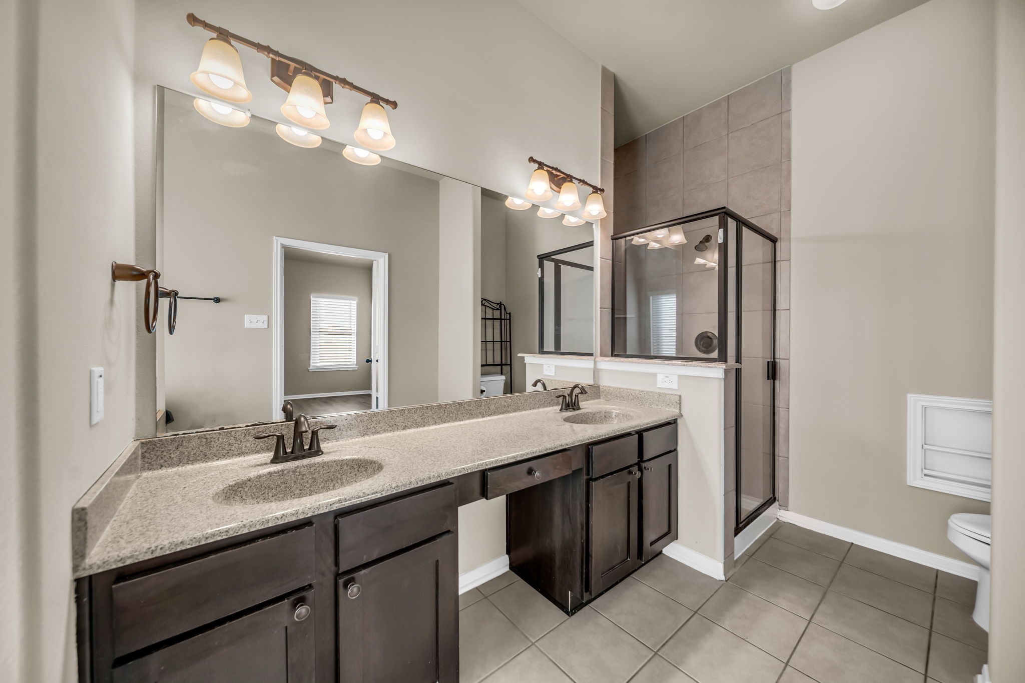 2614 Winding Creek Way Conroe, TX 77385 - Photo 12 of 23 a bathroom with a sink double vanity and a mirror