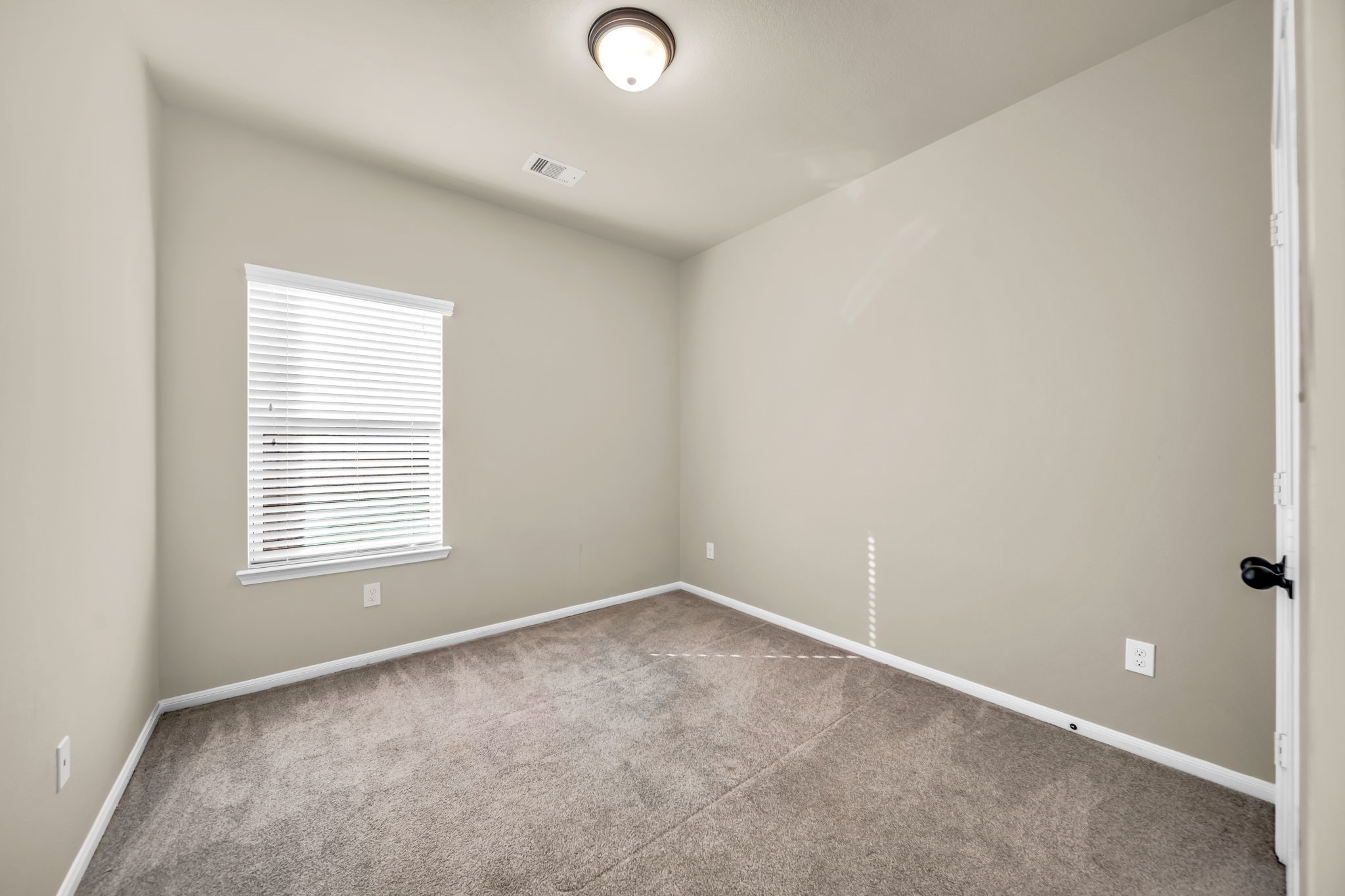 2614 Winding Creek Way Conroe, TX 77385 - Photo 14 of 23 an empty room with a window