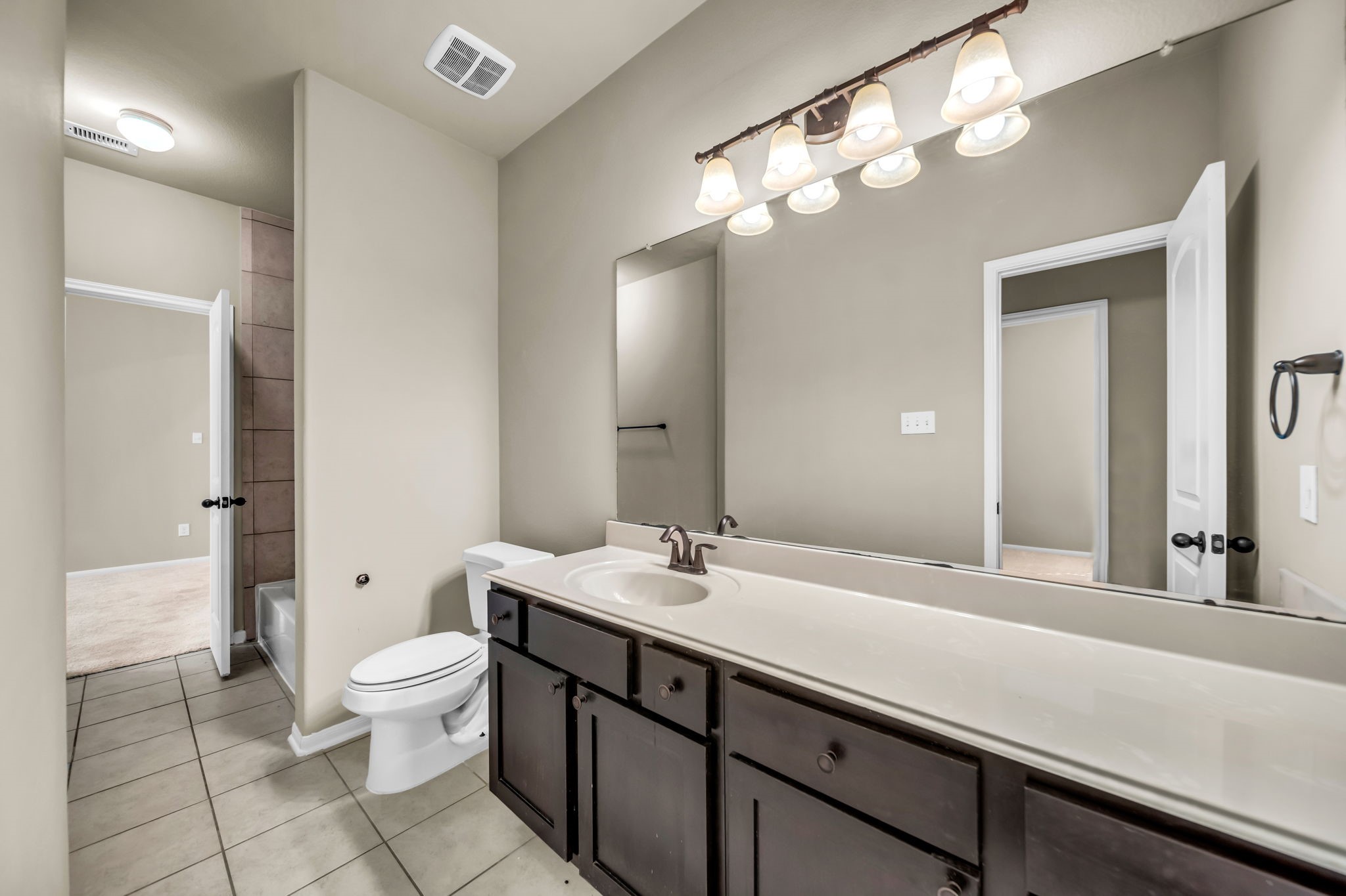 2614 Winding Creek Way Conroe, TX 77385 - Photo 15 of 23 a bathroom with a sink a toilet and a mirror