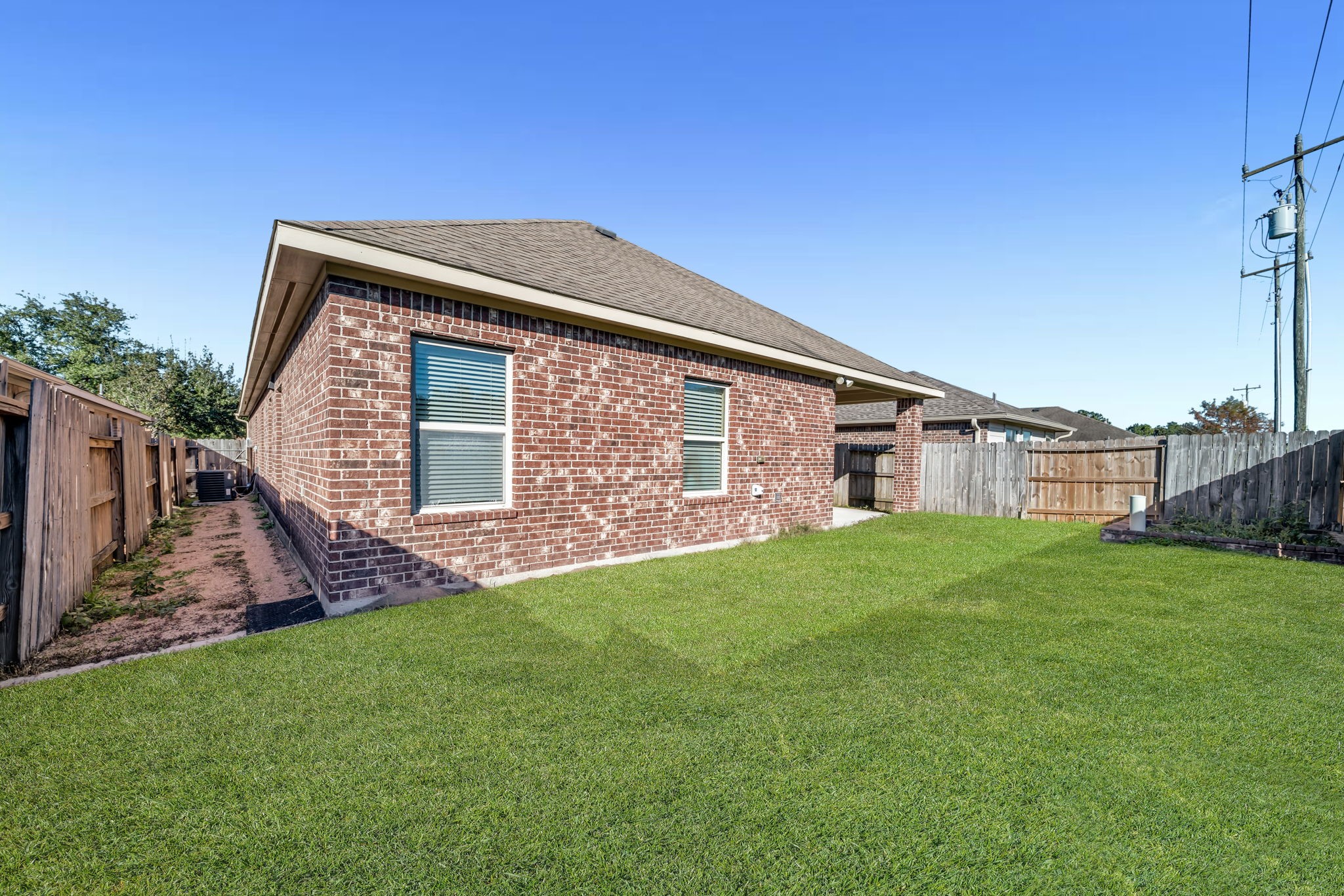 2614 Winding Creek Way Conroe, TX 77385 - Photo 20 of 23 a front view of a house with a garden