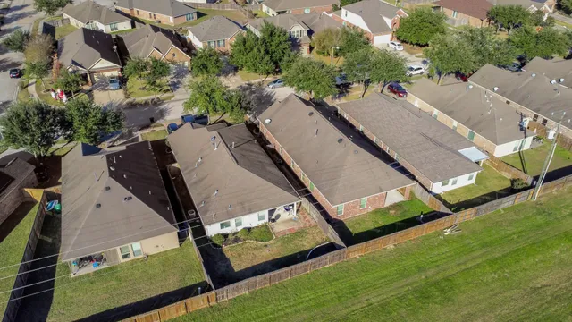an aerial view of residential houses with outdoor space