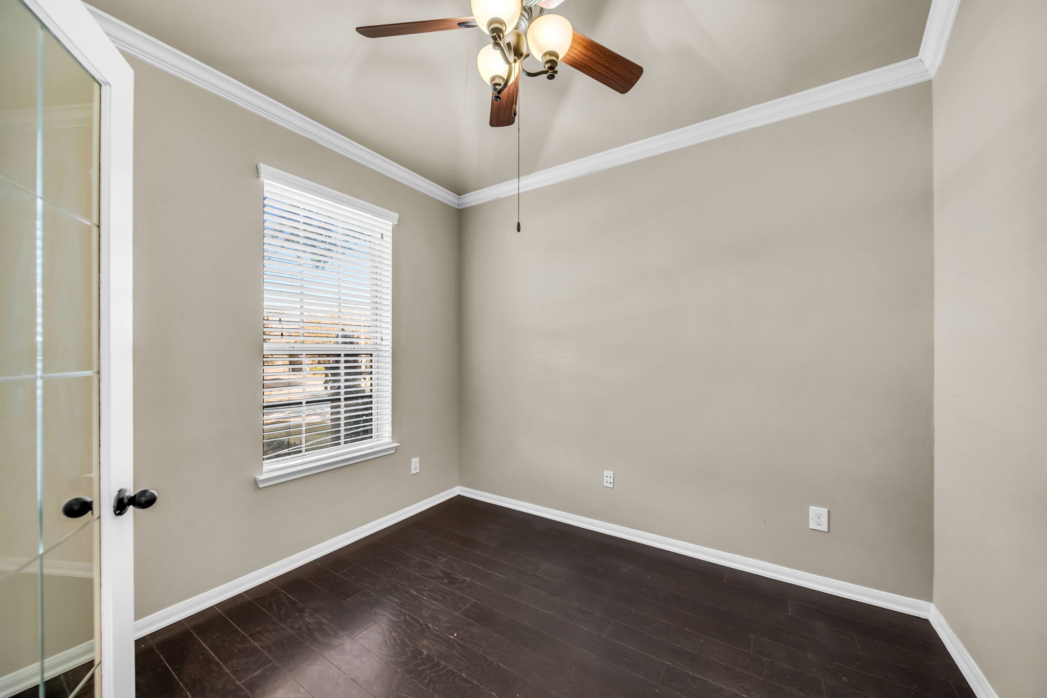 2614 Winding Creek Way Conroe, TX 77385 - Photo 3 of 23 an empty room with wooden floor chandelier fan and windows