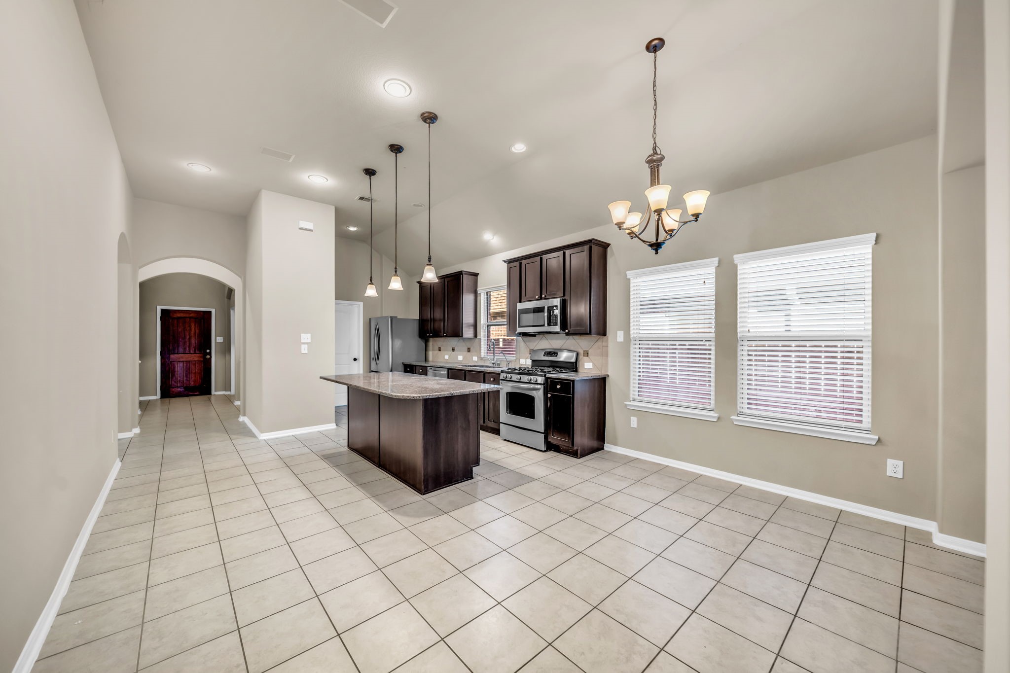 2614 Winding Creek Way Conroe, TX 77385 - Photo 6 of 23 a kitchen with stainless steel appliances kitchen island granite countertop a sink and cabinets