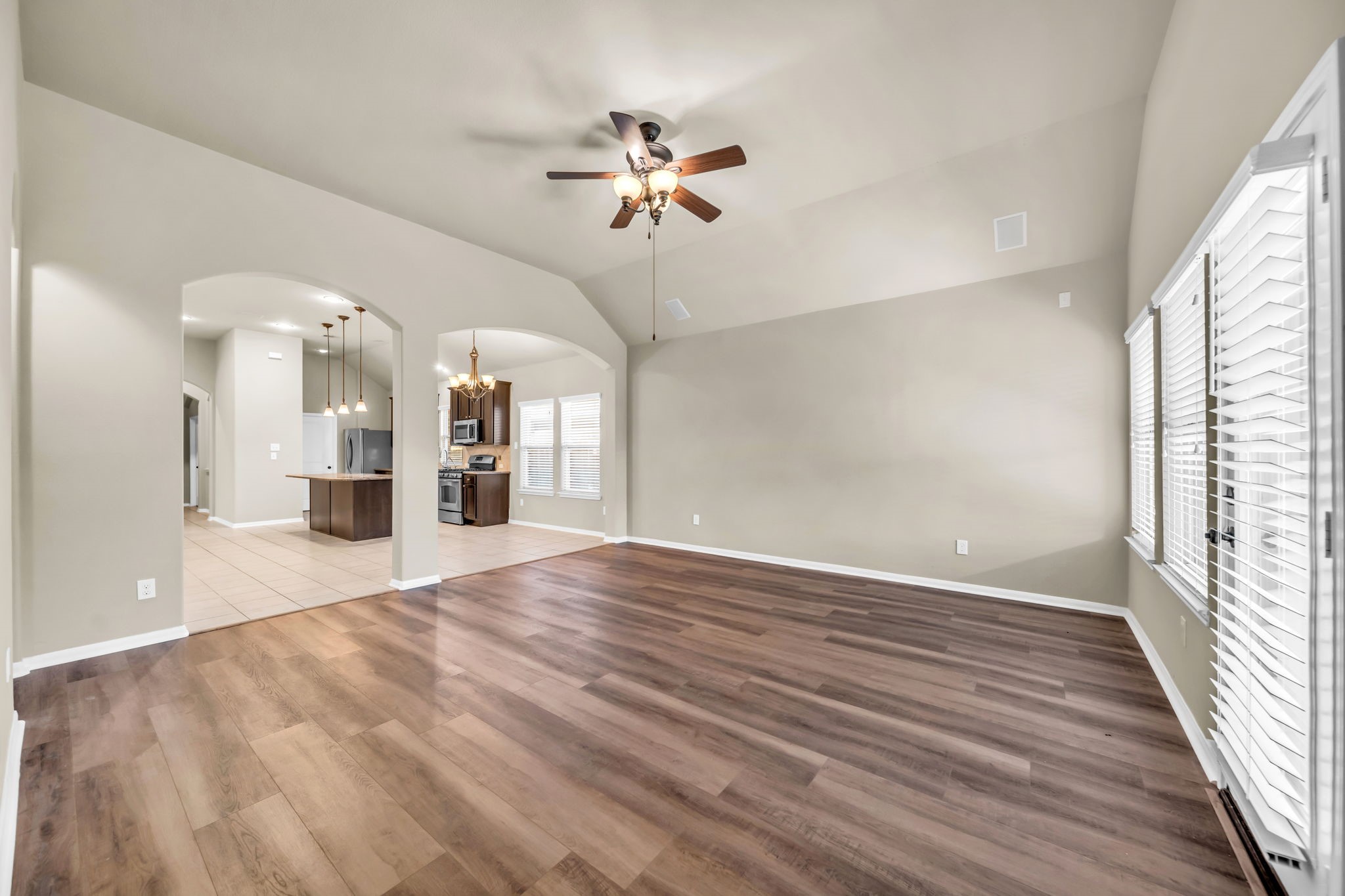 2614 Winding Creek Way Conroe, TX 77385 - Photo 7 of 23 wooden floor in an empty room with a window