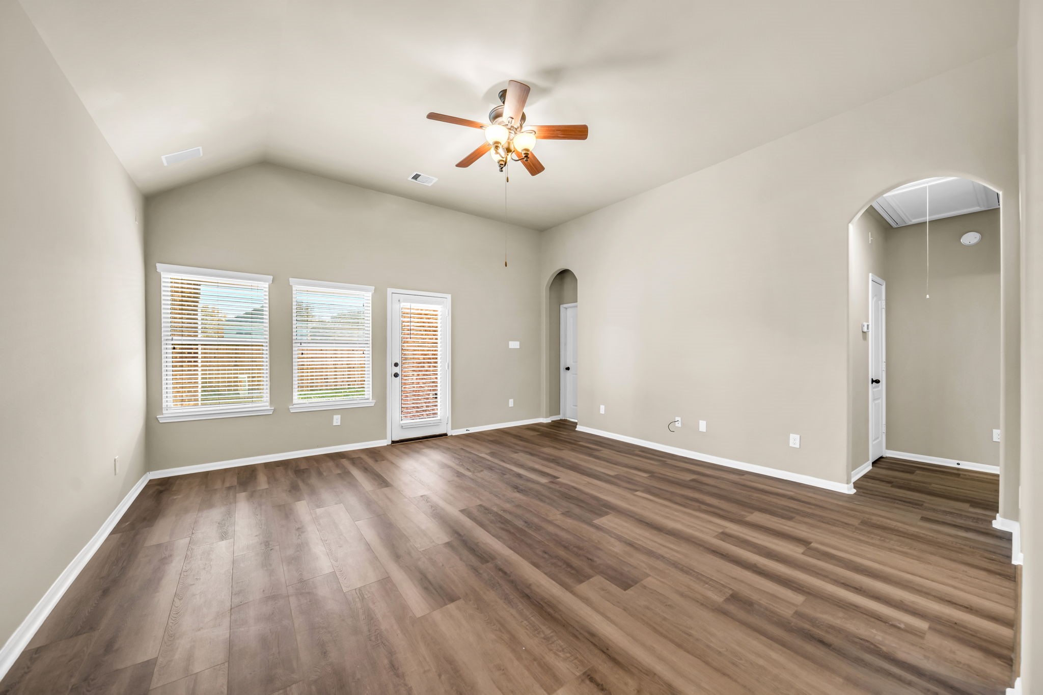 2614 Winding Creek Way Conroe, TX 77385 - Photo 8 of 23 wooden floor in an empty room with a window