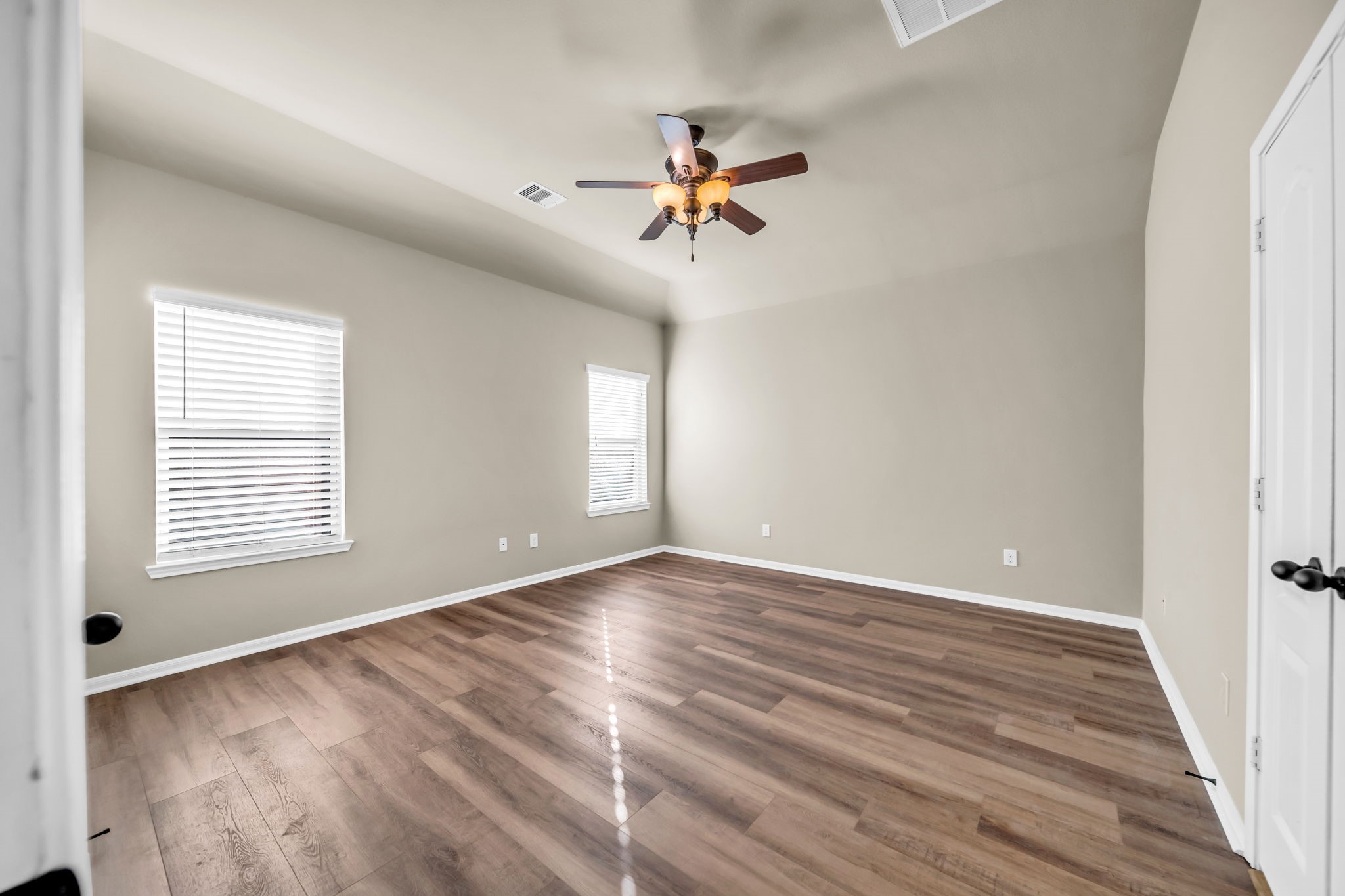 2614 Winding Creek Way Conroe, TX 77385 - Photo 9 of 23 a view of empty room with wooden floor and fan
