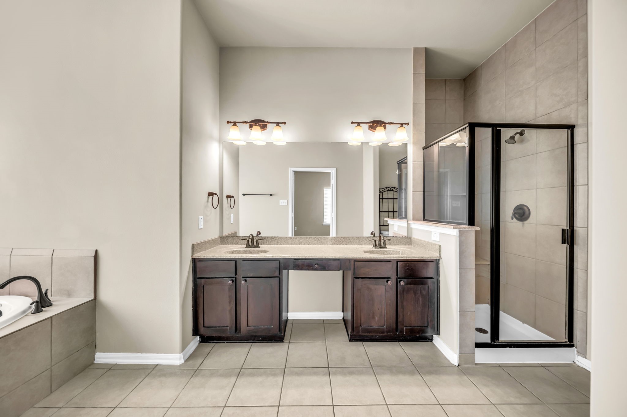 2614 Winding Creek Way Conroe, TX 77385 - Photo 10 of 23 a large bathroom with a sink a large mirror and a bathtub