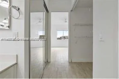 a bathroom with a glass shower door and a mirror