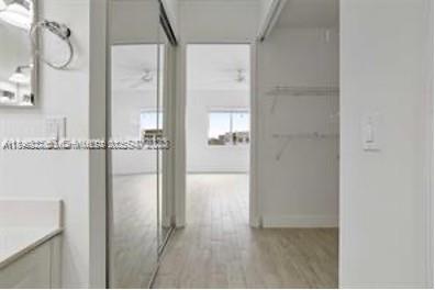 3600 Oaks Clubhouse Drive, Unit 509 Pompano Beach, FL 33069 - Photo 11 of 22 a bathroom with a glass shower door and a mirror