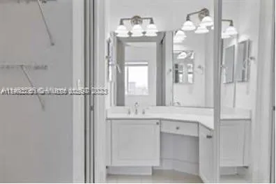 a bathroom with a double vanity sink and a mirror