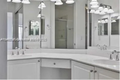 a bathroom with a sink vanity and a mirror