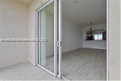 3600 Oaks Clubhouse Drive, Unit 509 Pompano Beach, FL 33069 - Photo 16 of 22 an empty room and chandelier fan