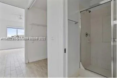 a bathroom with a granite countertop sink and shower