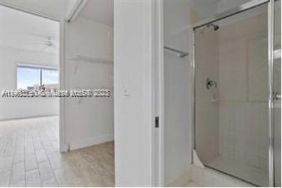 3600 Oaks Clubhouse Drive, Unit 509 Pompano Beach, FL 33069 - Photo 17 of 22 a bathroom with a granite countertop sink and shower