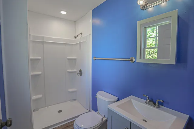 a bathroom with a sink toilet and shower